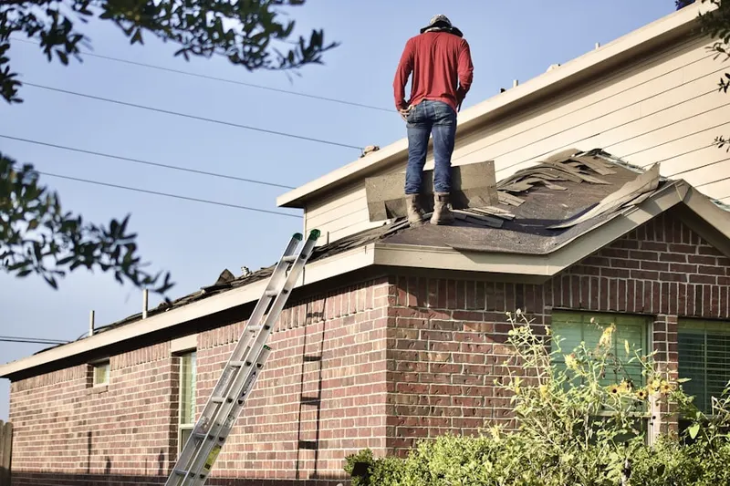 Professional roofer working on a residential roof in Brittany Pointe Estates